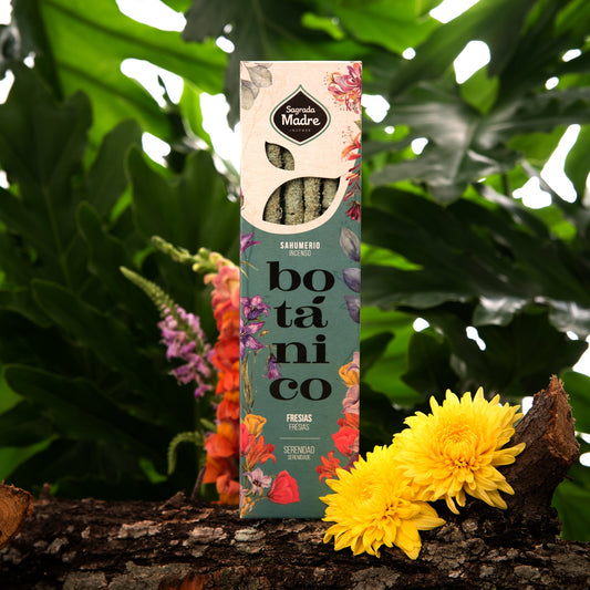 Sahumerio Botánico Fresias con fondo de vegetación y flores amarillas.